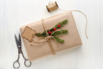 Christmas gift, thread, scissors, pine needles.