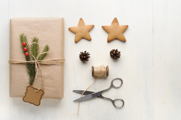 Christmas gift, thread, scissors, pine cone, pine needles.