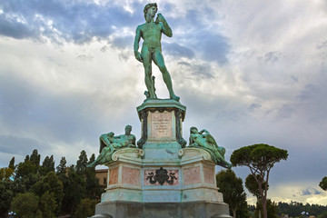 Bronze cast statue of David at Michelangelo Square (Piazzale Michelangelo) on hill in evening,...