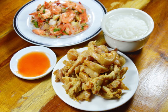boiled rice eat with fried chicken and spicy shrimp salad