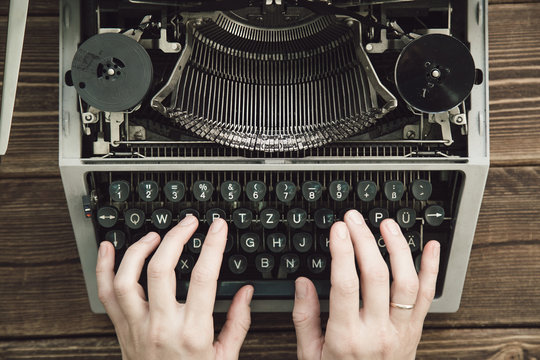 Fototapeta Writer typing with retro writing machine. View from above.