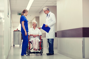 medics and senior woman in wheelchair at hospital