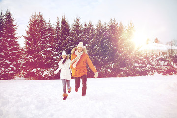 Fototapeta na wymiar happy couple running in winter snow