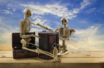Skeleton pirate sitting on a treasure chest and old wood floor,b