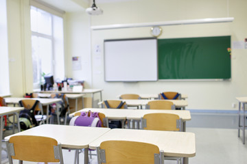 school classroom with desks and blackboard