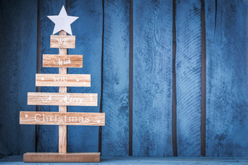 Christmas tree decoration on wooden blue background. DIY.