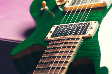 Electric guitar body and neck detail on wooden background