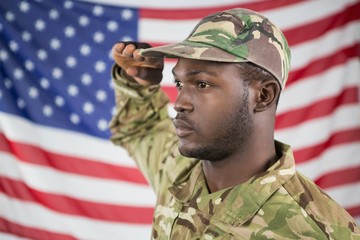 Soldier saluting against american flag