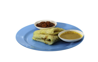Two slices of homemade plain pancake with curry and shrimp gravy or sambal udang on cyan plate on white background