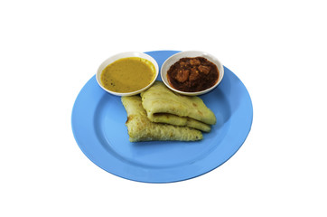 Two slices of homemade plain pancake with curry and shrimp gravy or sambal udang on cyan plate on white background