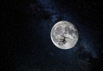 Combat helicopter on the moon and starry sky background 