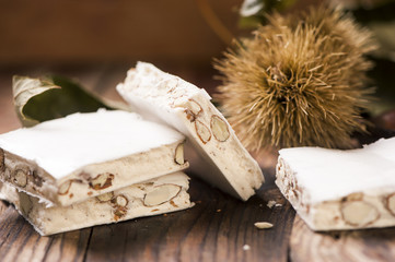 Delicious Italian festive torrone or nougat on wooden table