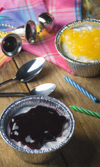 Small peach and blueberry pies on wooden block