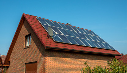 Fototapeta premium Solar panel on a red roof
