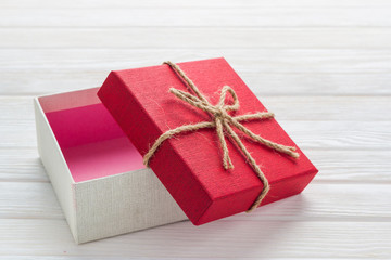 Gift box on a white wooden background.