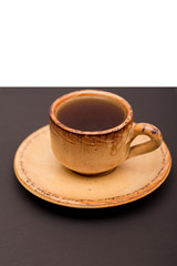 Small cup of coffee on a dark and white background