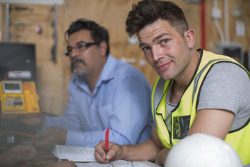 Confident young man attending an electrician workshop
