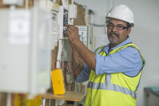 Electrician using voltmeter
