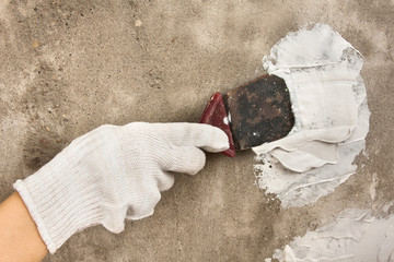 hand plastering concrete wall with spatula