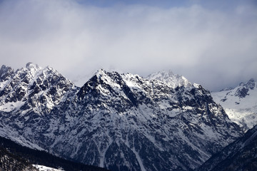 Snow sunlight mountain in haze at winter day