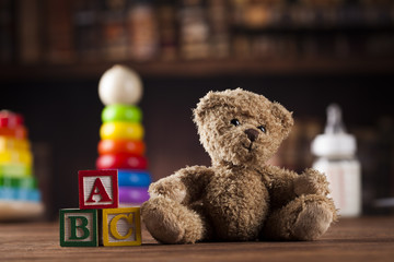 Cute teddy bear on wooden background