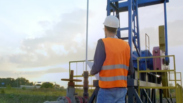 A Man Inspects Oil Rig