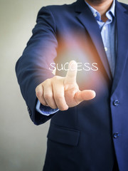 Businessman pointing at success word on virtual screen, Business concept.