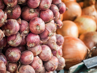 Pile of red onions at fresh market in Thailand