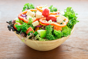 Kiwi sauce and mix salad with fruit and vegetable on wooden bowl