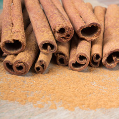  cinnamon sticks on wooden background
