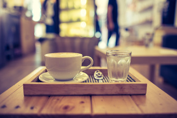 view vintage  latte art coffee and cool water in coffee shop