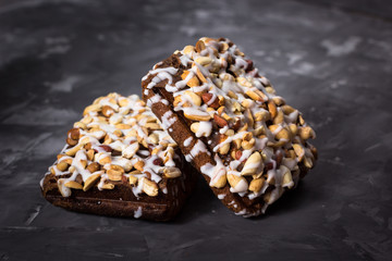 piece of cake, cookies with nuts and white icing on concrete bac