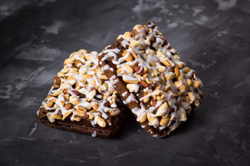 piece of cake, cookies with nuts and white icing on concrete bac