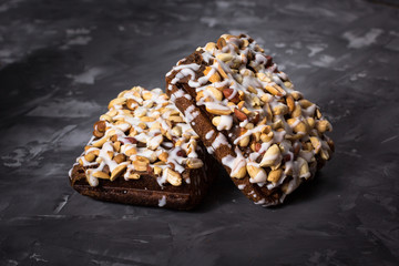 piece of cake, cookies with nuts and white icing on concrete bac