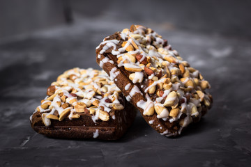 piece of cake, cookies with nuts and white icing on concrete bac