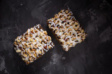 piece of cake, cookies with nuts and white icing on concrete bac