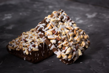 piece of cake, cookies with nuts and white icing on concrete bac