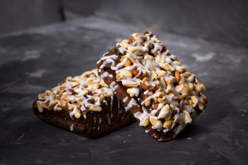 piece of cake, cookies with nuts and white icing on concrete bac