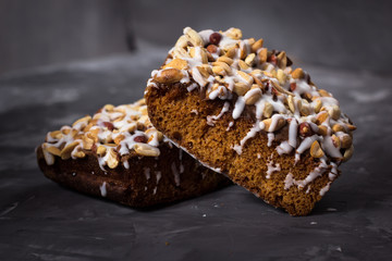 piece of cake, cookies with nuts and white icing on concrete bac