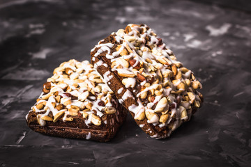 piece of cake, cookies with nuts and white icing on concrete bac