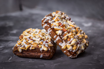piece of cake, cookies with nuts and white icing on concrete bac