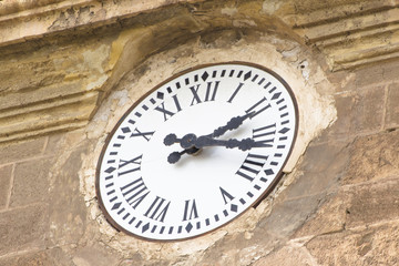 Roman numerals antique clock on a cathedral.