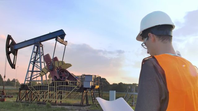 The Worker Examines Oil Pump