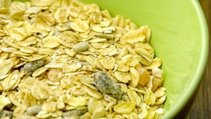 Black chia seeds being sprinkled over fruit and oat breakfast cereal, slow motion - Powered by Adobe