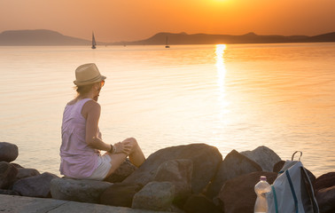 Adult woman admiring the sunset after a long journey