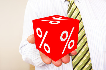 Man holds cubes with percent sign