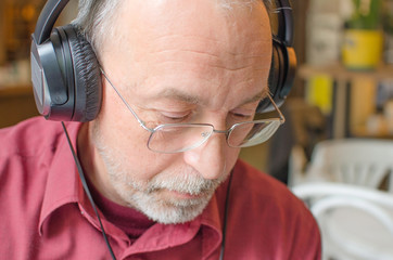Aged man listening to music