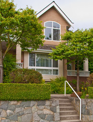 Stone staircase with white metal hand rails leading to the front door of townhouse