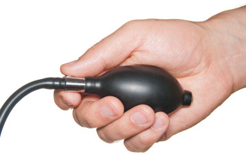 Blood pressure rubber bulb in hand isolated on white.