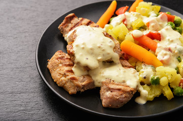 Grilled pork tenderloin and boiled vegetables with cream mustard sauce.